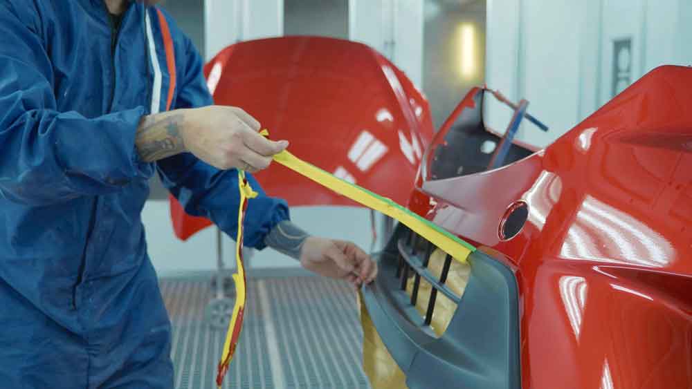  collision repair services tech working on bumper