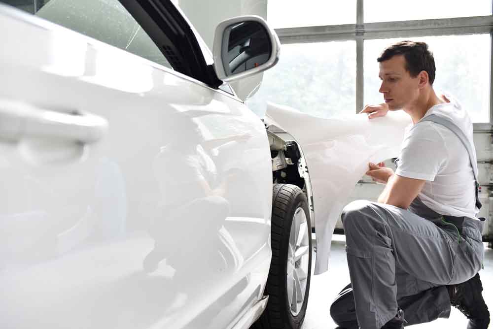 fender-repair collision repair services tech working on car